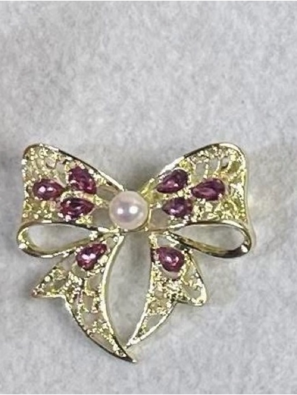 Gold-Tone Bow Brooch with Pink Stones and Pearl Center